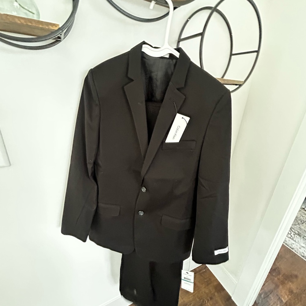 Formal suit coat with pants. Brand new never worn. Boys size 16.